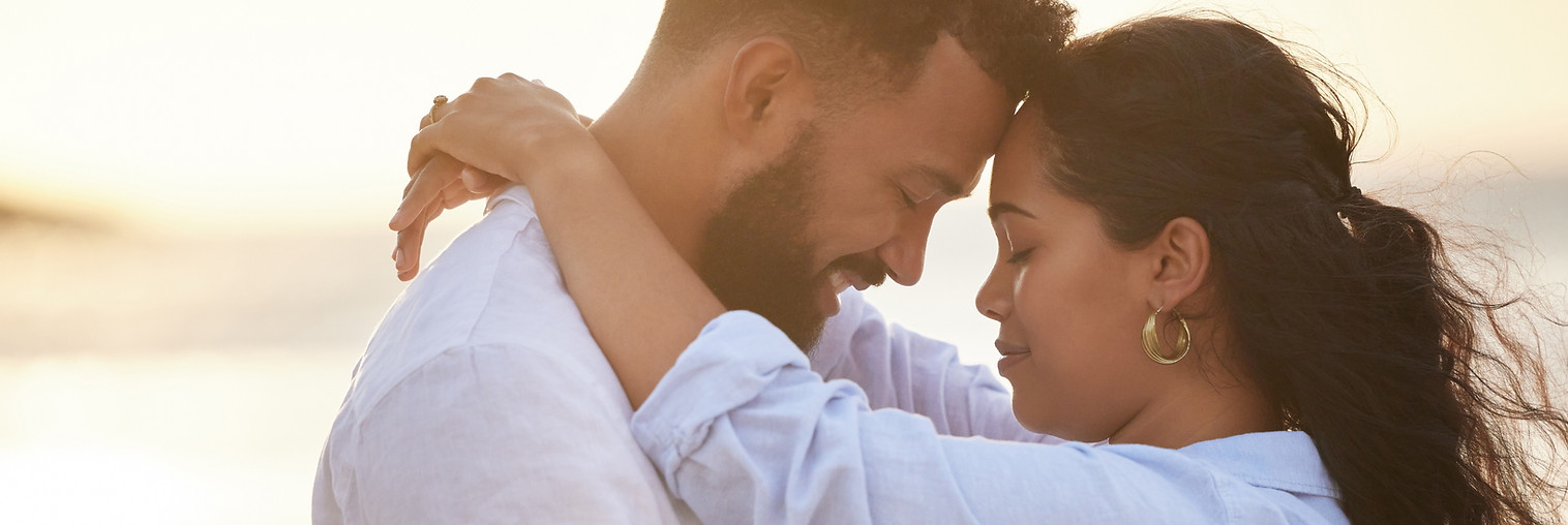 Happy couple, hug and beach with embrace for love, bonding or support in care on outdoor h