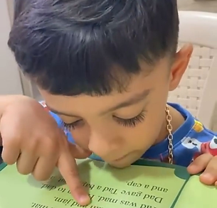 young boy focusing on his reading skills