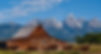 A historic barn pictured in front of the Grand Tetons.