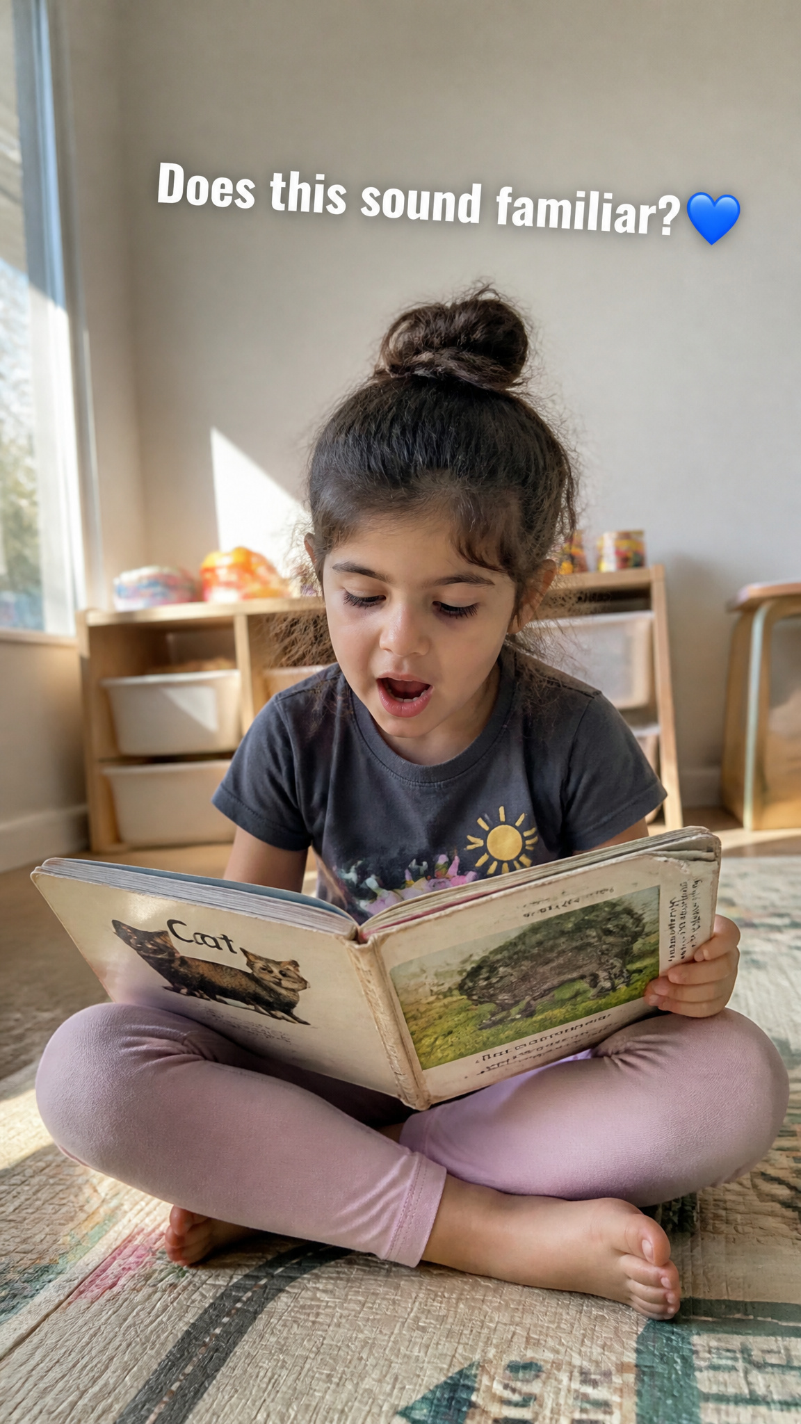 Young child looking at a book during a communication activity.