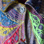 Close-up pf front of the embroidered cape.