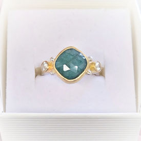 Elegant gemstone ring with a square-cut emerald gem set in gold with a silver band