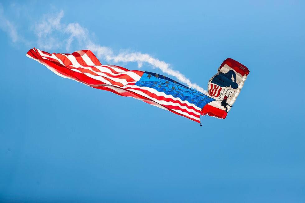 Folds of Honor paraglider holds American Flag above opening ceremonies.