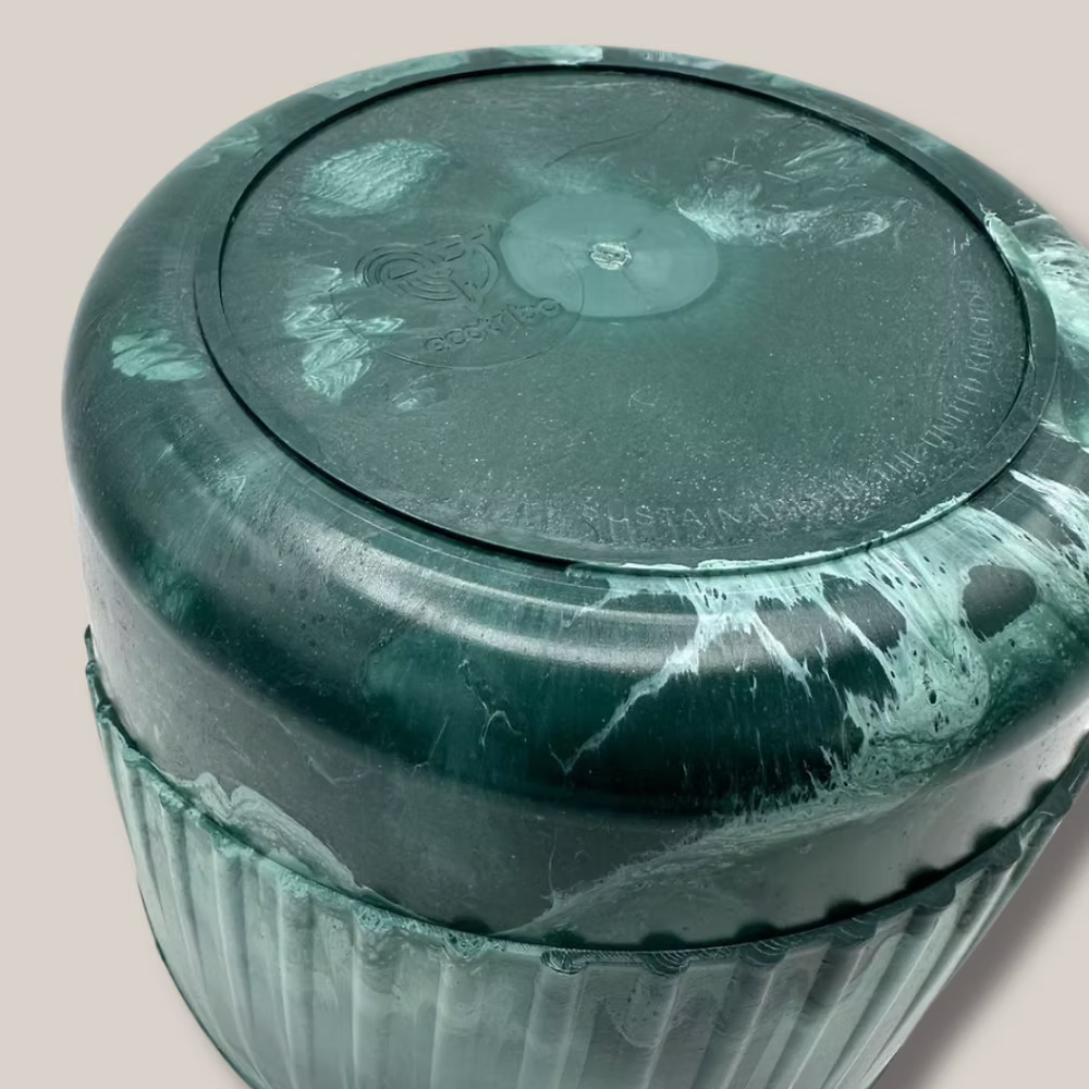 Eco-friendly recycled plant pot by The Bearded Plantaholic displayed among lush indoor plants.