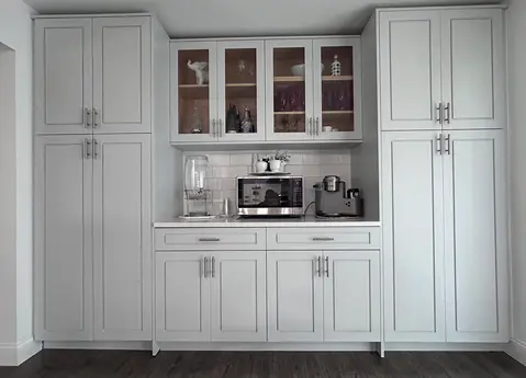 Gray kitchen cabinets with glass doors and built-in appliances