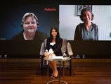 Woman moderating hybrid event with two virtual speakers