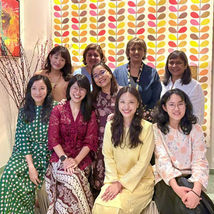 Nine women smiling, posing at The AWL Photo Gallery