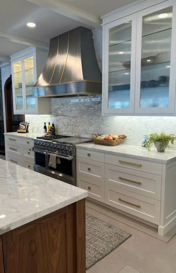 Glass detail on upper cabinetry + unique cabinet hardware selection.