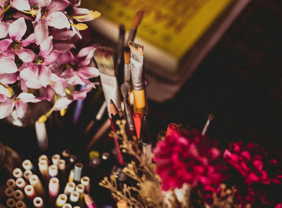 overcoming creative blocks art supplies on a desk with flowers