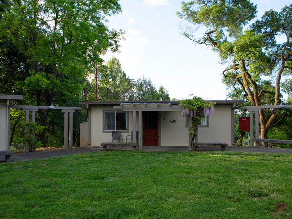 Cottage with lawn and wisteria