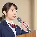 Intemediate Competitive Student smiling at the audience in a regional public speaking contest