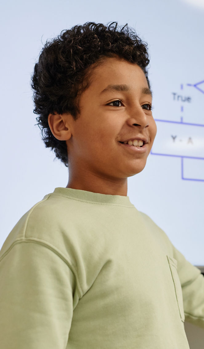 Portrait of smiling teenage boy giving p