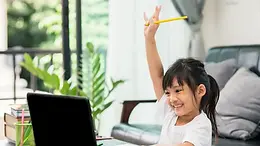 Young girl excitedly raising her hand during a live online one-on-one public speaking session