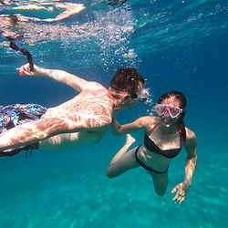 Swim and snorkel in clear water accessible only by sea