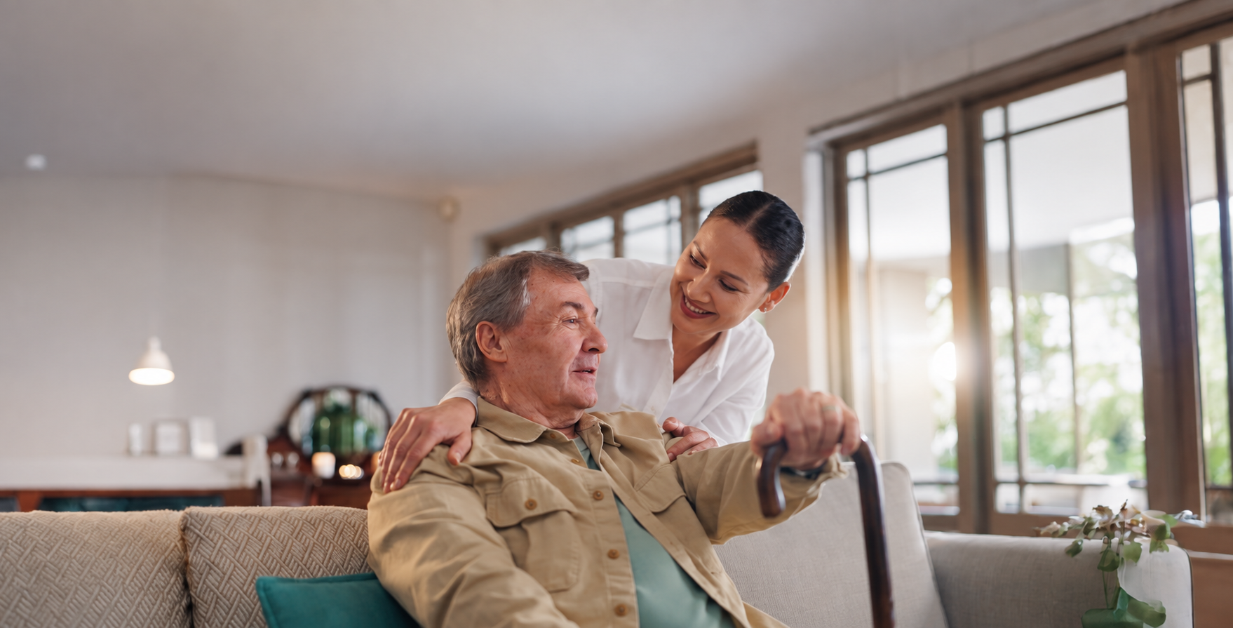 Carer supporting an older man at home