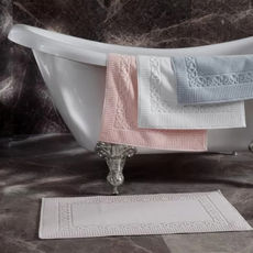 There are four bath mats. One is on the floor, the others are hanging on bathhub.