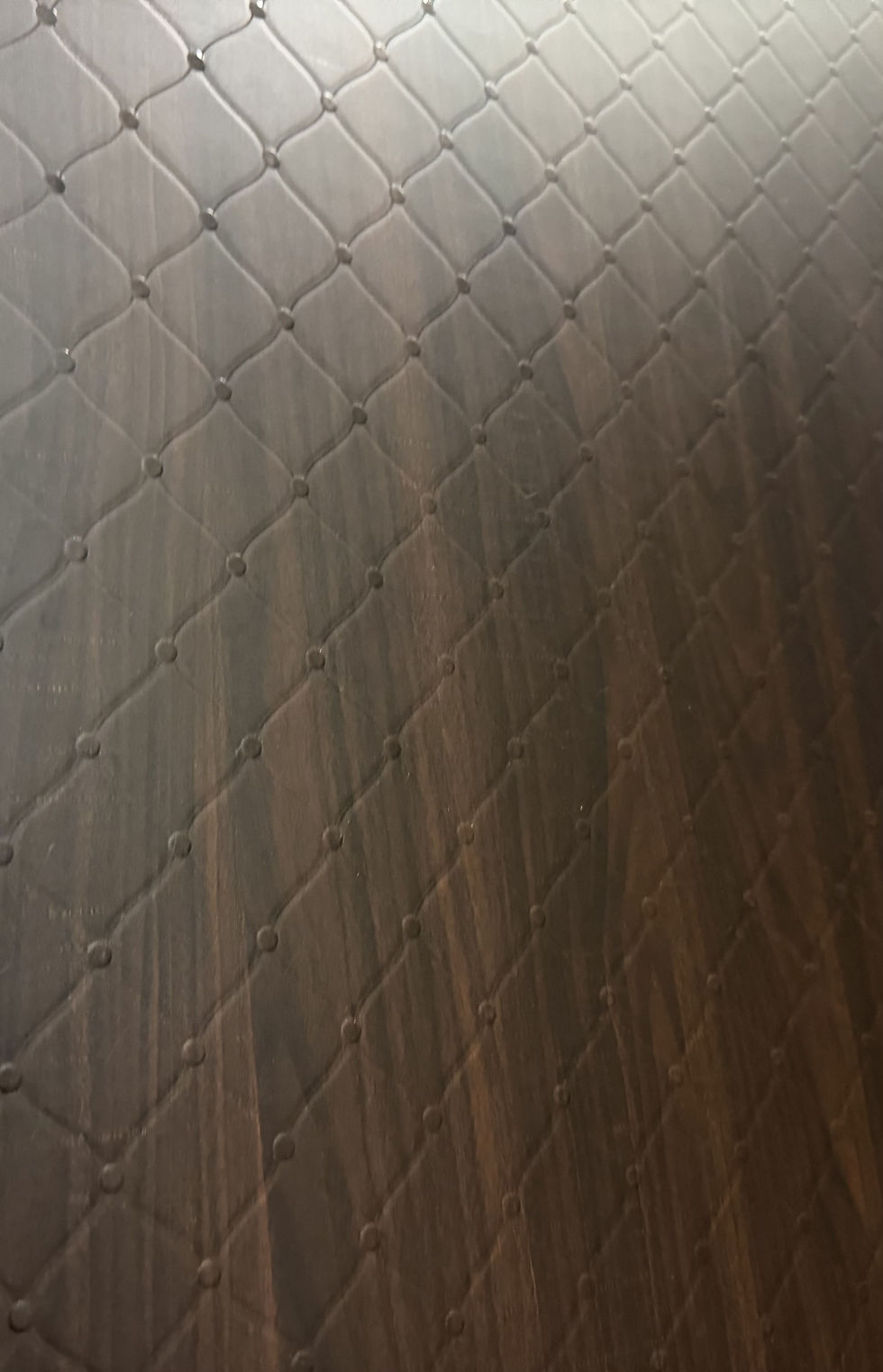 Espresso brown quilted wood-texture lamination sheet close-up