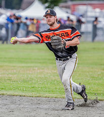 A male softball player prepared a throw from the infield.