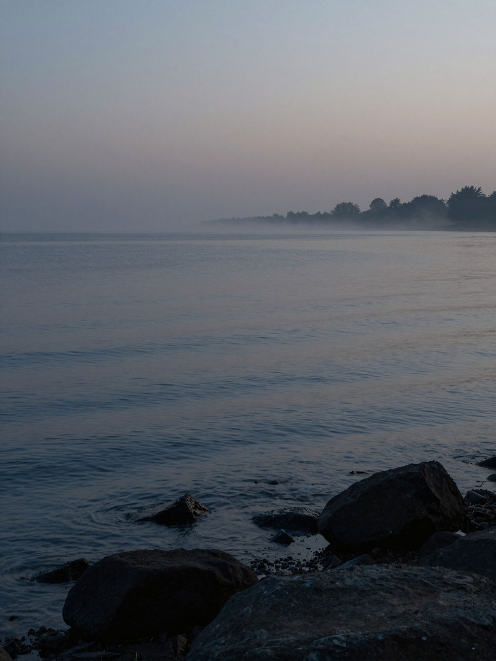 Calm misty morning over a lake with rocks with a course in miracles quote