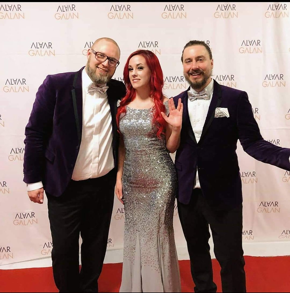 Linn-marie in a stunning, sparkly dress at Alvar Galan, doing the Vulcan salute with her hand.