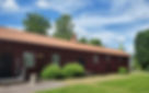 A picture of the exterior of the new studio. A single storey house with red front, white window frames and black doors.