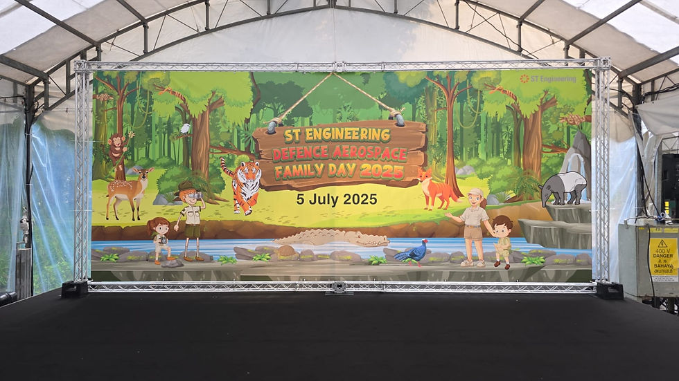 Emcee Singapore - Event of "ST Engineering Defence Aerospace Family Day 2025" featuring a jungle-themed backdrop with cute cartoon characters and animals, set for July 5, 2025.
