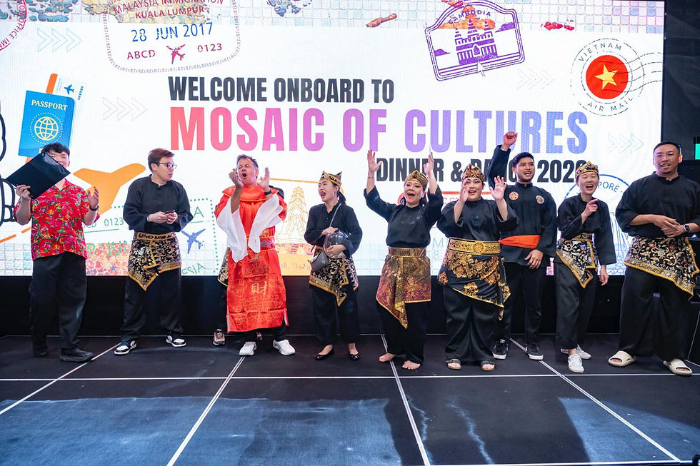 Emcee Singapore - A group of enthusiastic staff dressed in traditional costume on stage with the General Manager Mr. Rob McIntyre.