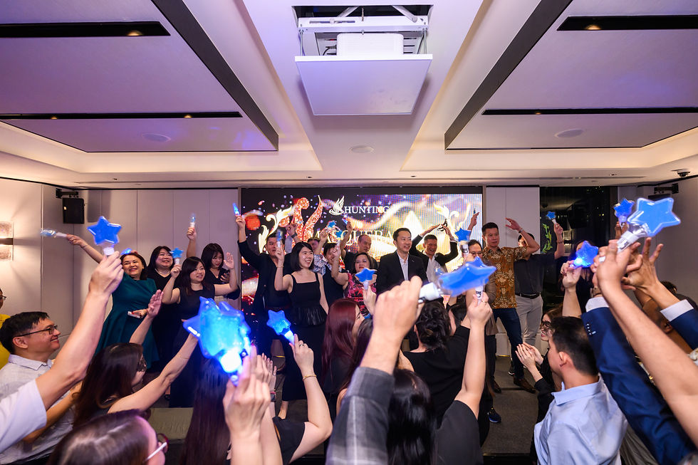 Emcee - At the finale, all staff gathered at the stage front singing and waving to the music, capturing the spirit of a successful event.