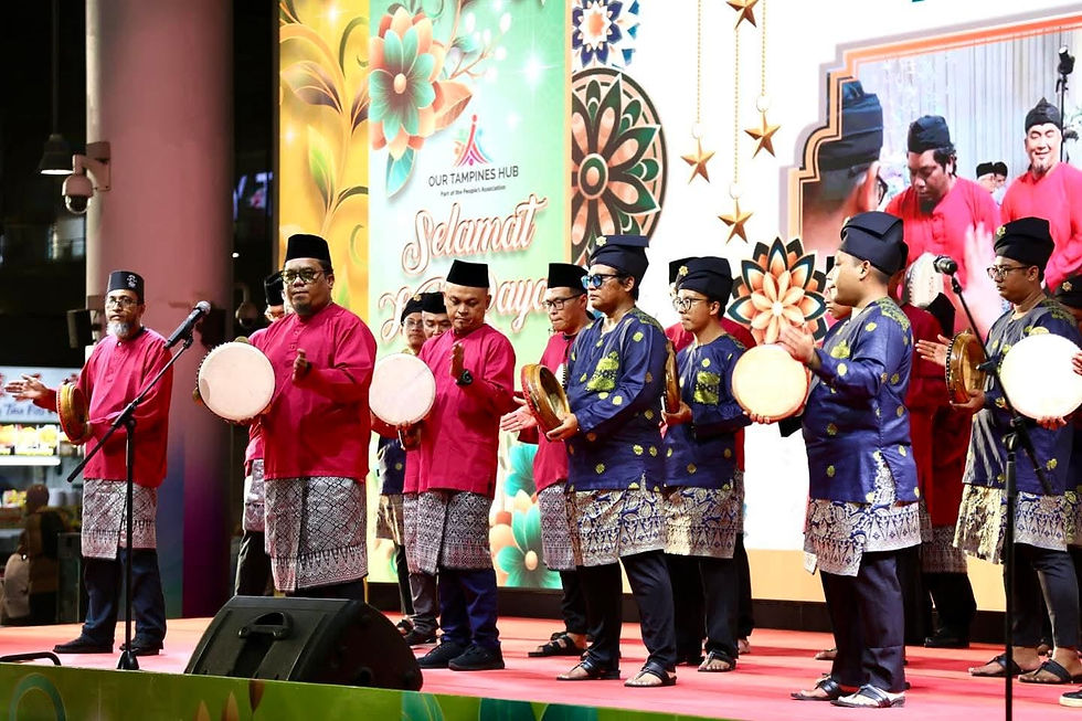 Emcee Singapore - A lively malay cultural performance at Our Tampines Hub, featuring performers in traditional malay attire playing hand drums on stage.