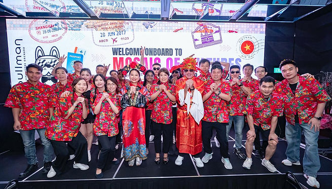 Emcee Singapore - Staff dressed in red and posed with their General Manager who is dressed as God of Fortune.