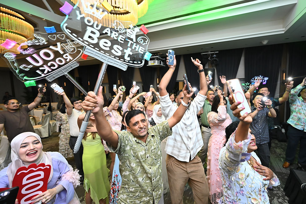 Emcee Singapore - A jubilant celebration erupted as a lively crowd waving signs and capturing the high moment with their phones at the party.