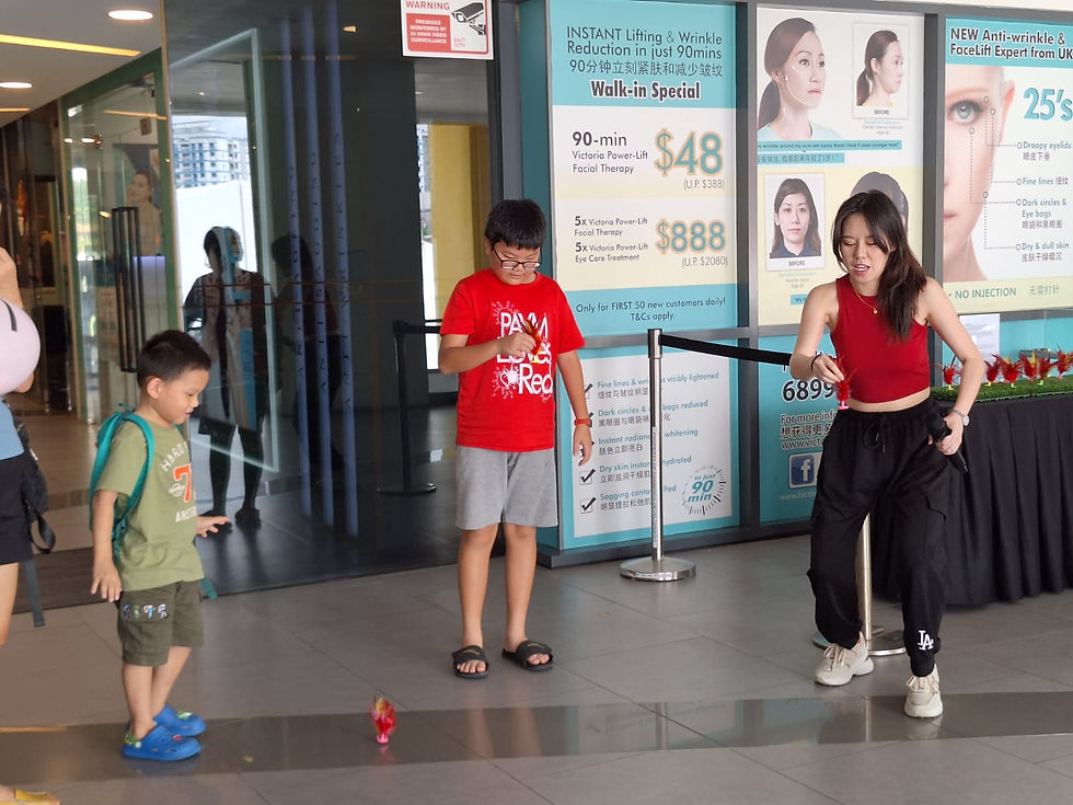 Emcee Singapore - Our emcee teaching the children how to play chapteh.