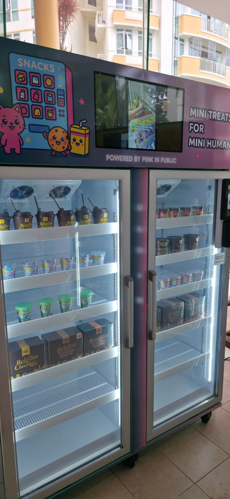 Emcee Singapore - The colourful vending machines offer a delightful selection of snacks like chocolates, adorned with cute cartoon characters.