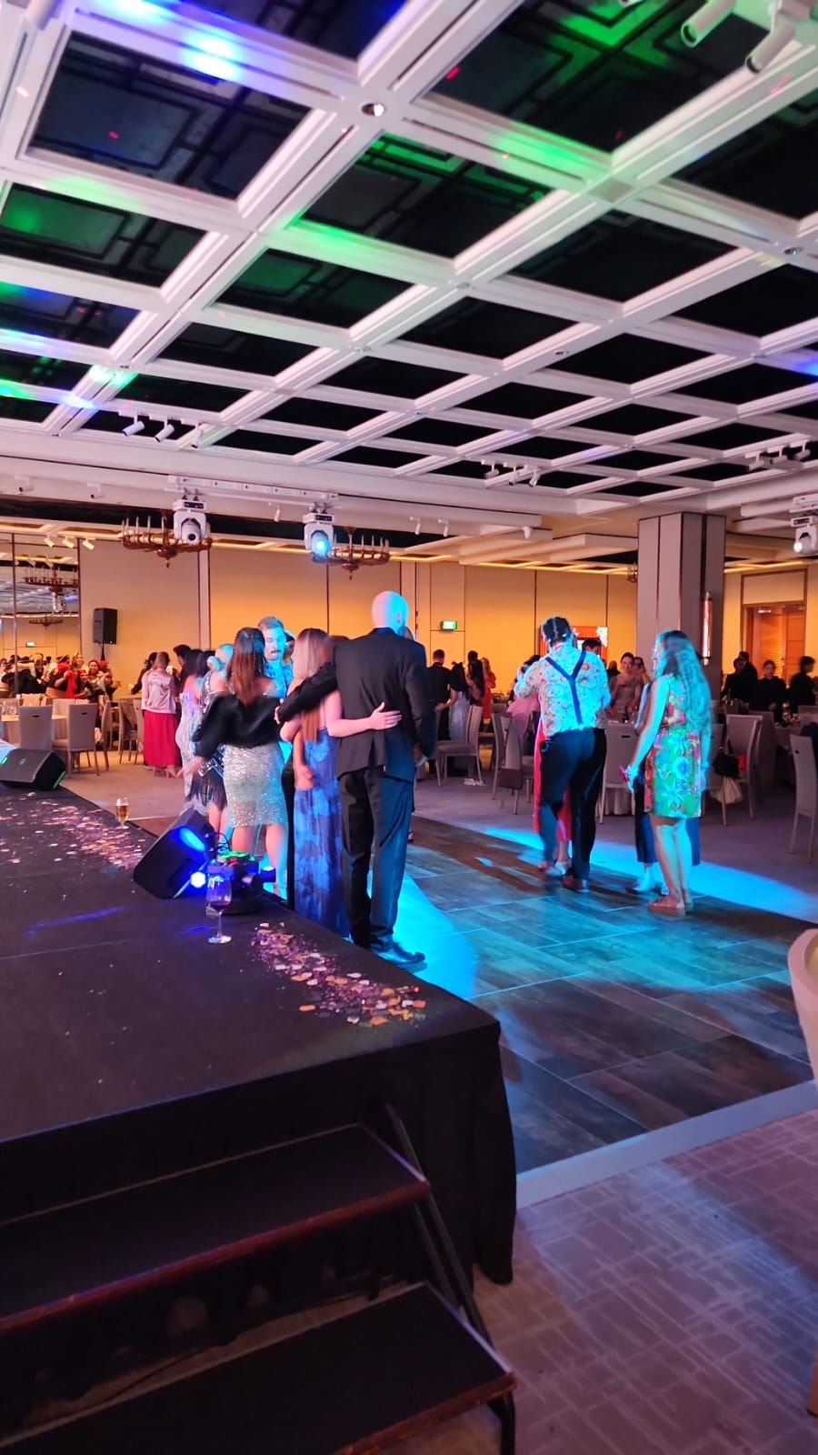 Emcee - Guests gathering on the dance floor for a group photo.