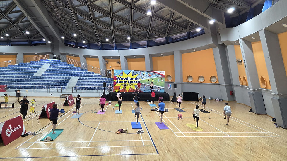 Emcee - Participants engage in a yoga session at the Woodlands Sport Quest event, held in Woodlands indoor sports hall.