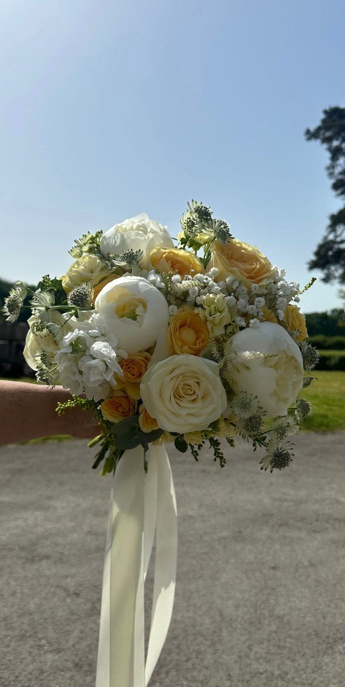 A romantic yellow and white bridal bouquet crafted by Extra Gorgeous Blooms, a wedding florist in Hampshire, Surrey and West Sussex