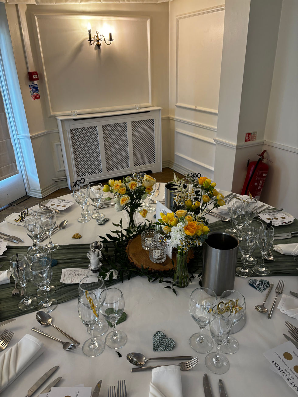 Elegant table setting with flowers and glassware.