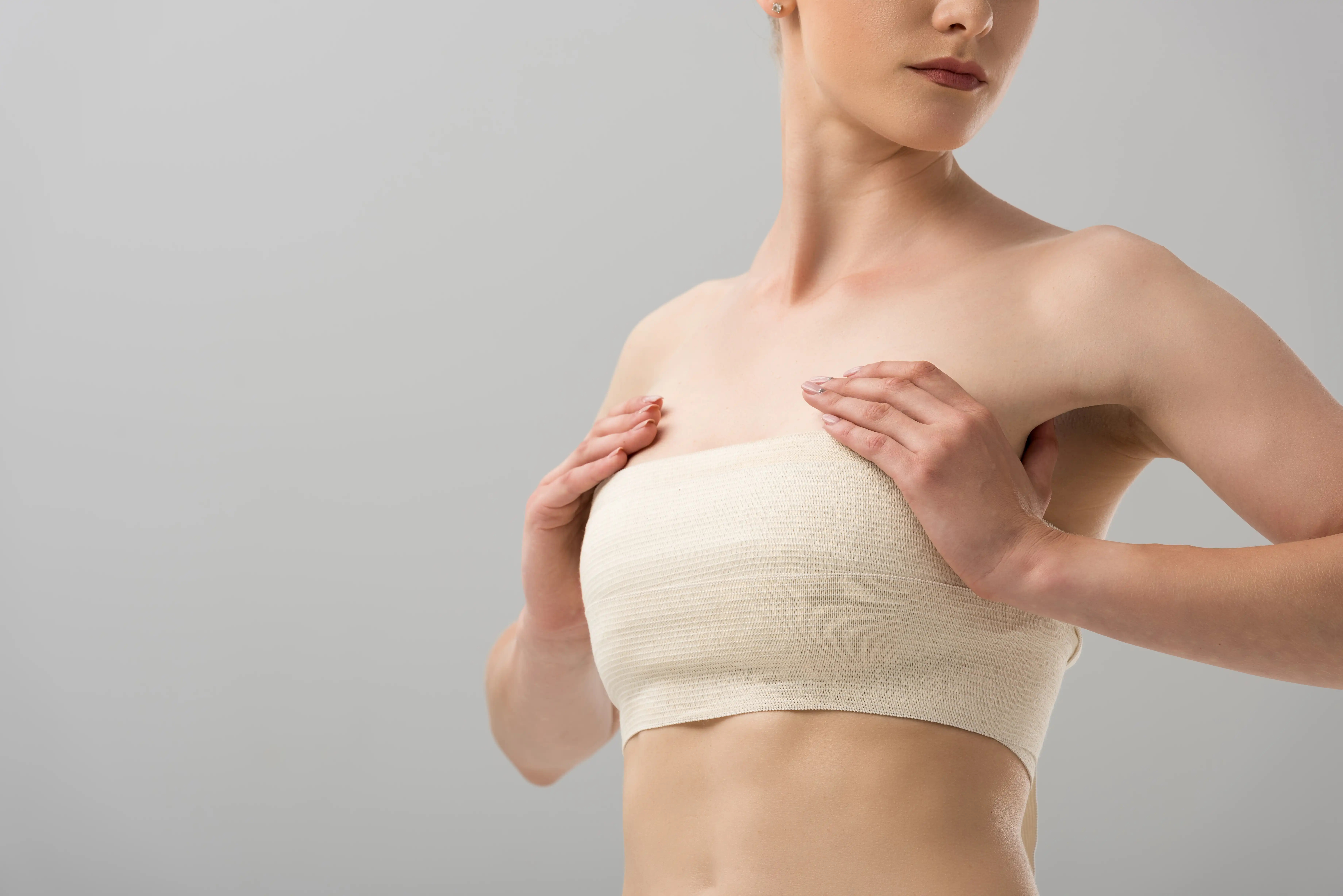 cropped-view-of-woman-with-breast-bandage-isolated-2022-02-05-12-52-22-utc copy.webp