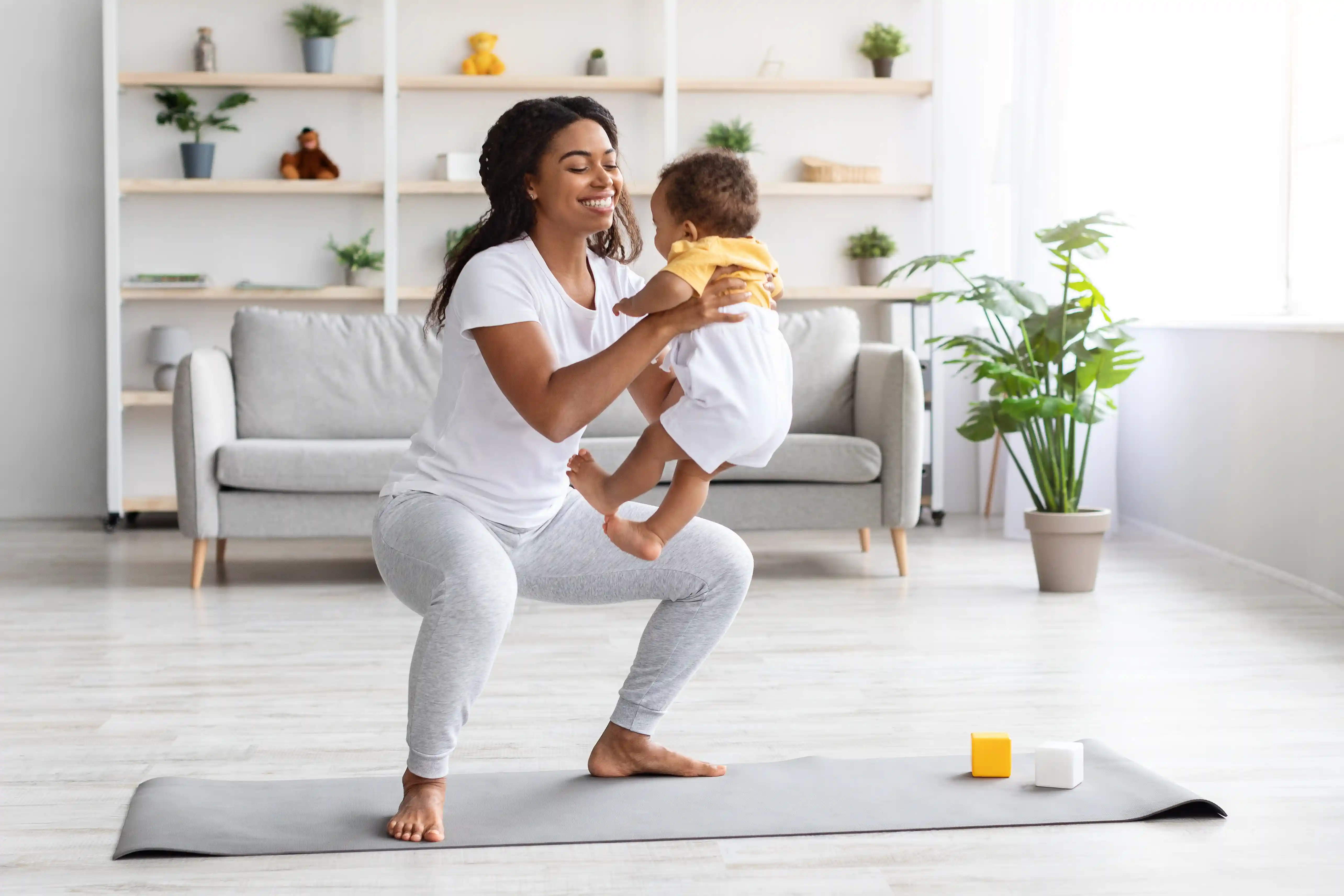 workout-with-baby-cheerful-black-woman-exercising-2022-12-16-09-15-04-utc.webp