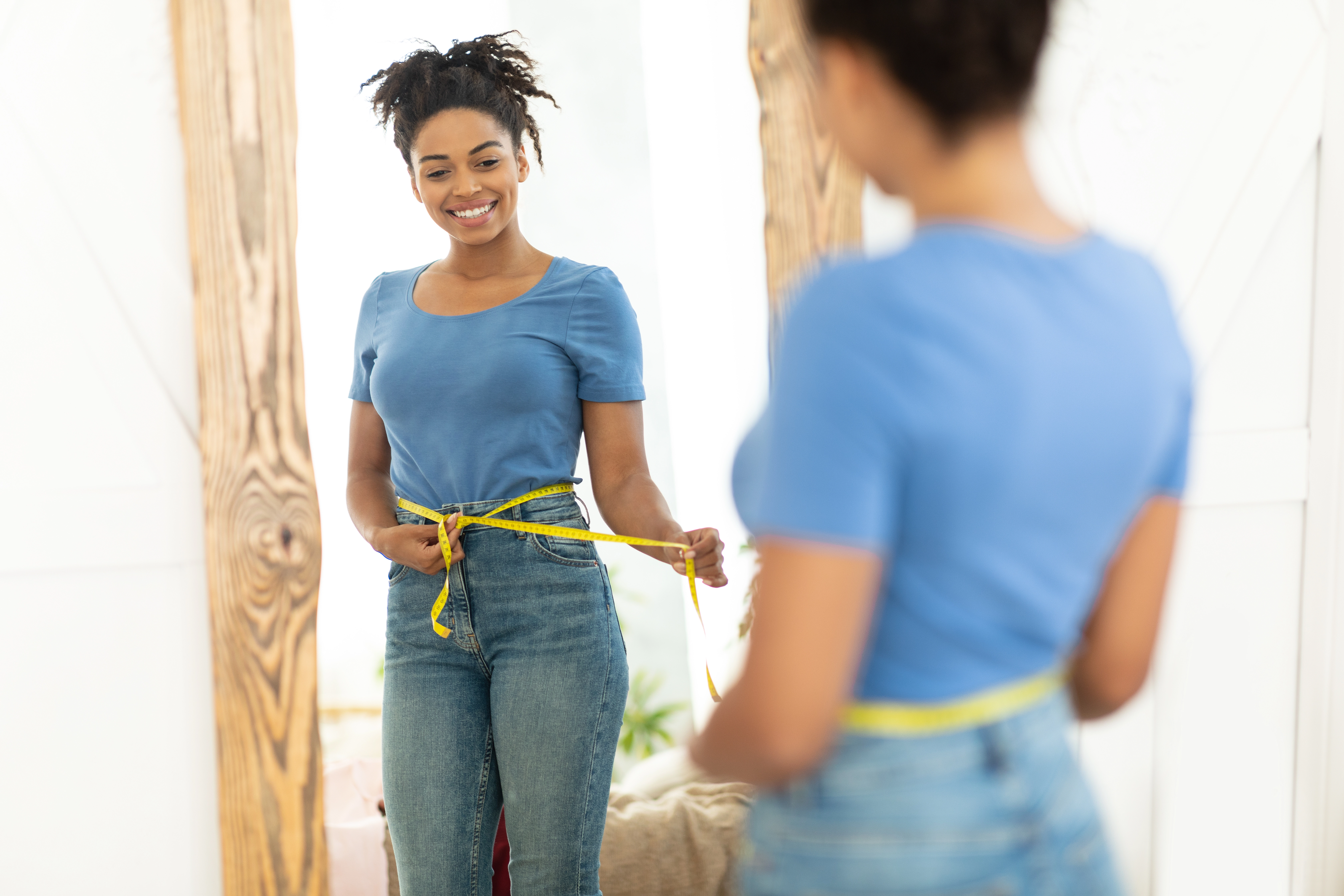 happy-black-girl-after-weight-loss-measuring-waist
