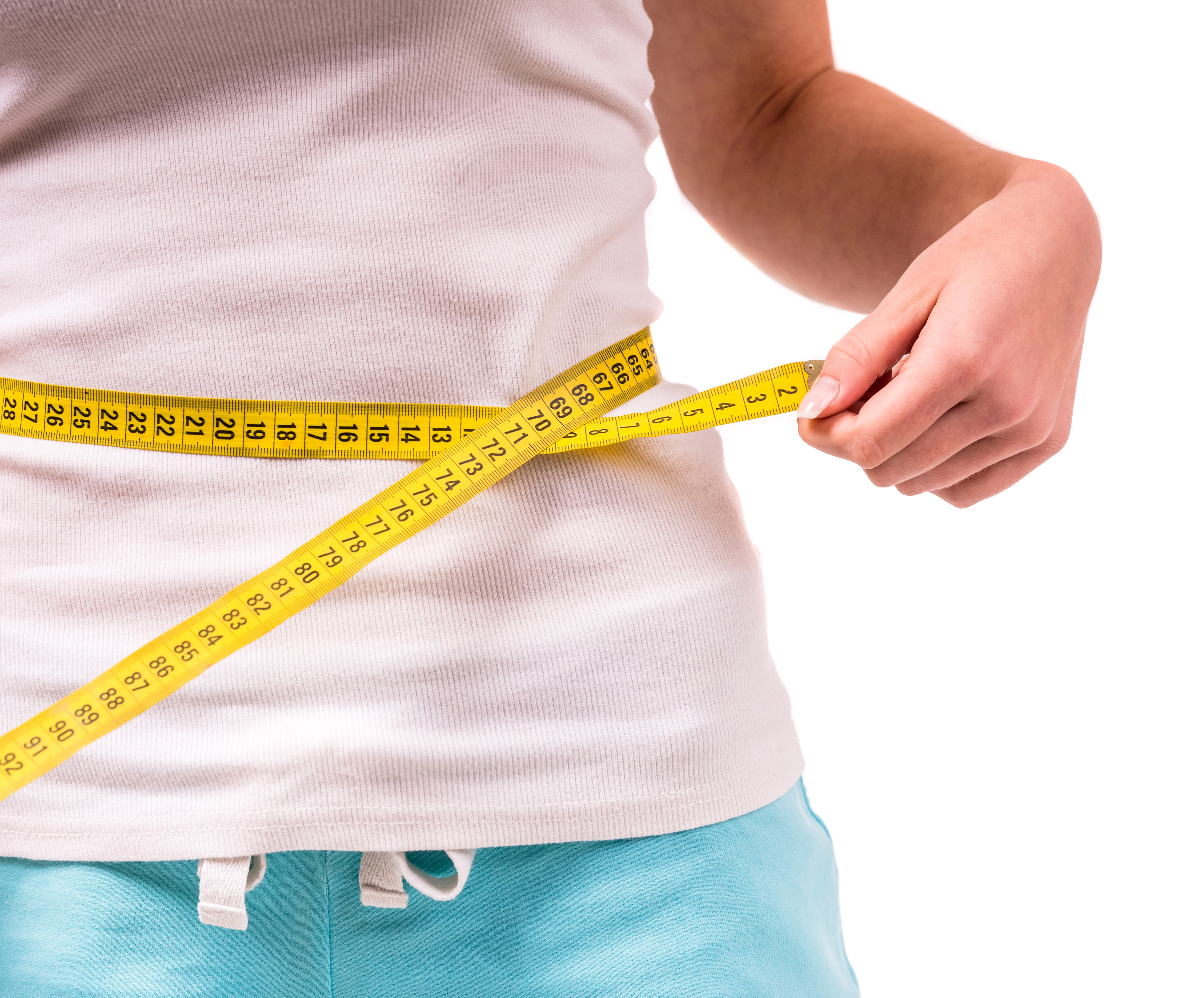 a girl measuring her waist