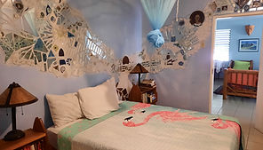 full size bed in private room at Calabash House