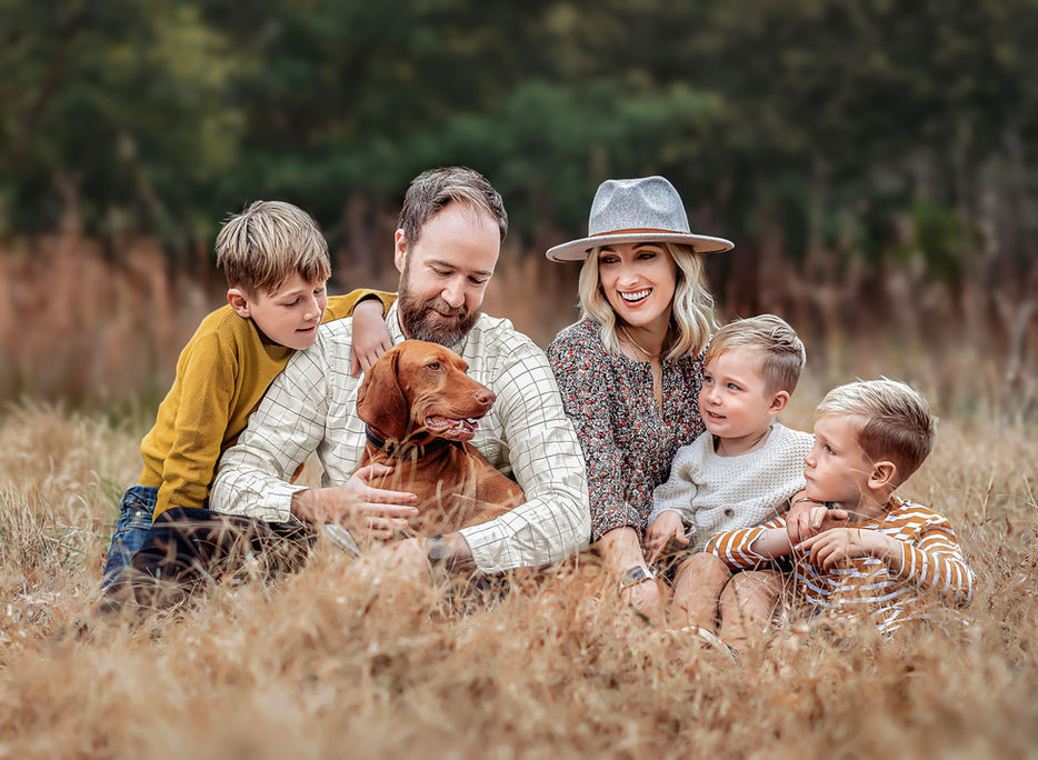 Family of five with their dog during portrait photo session outdoors