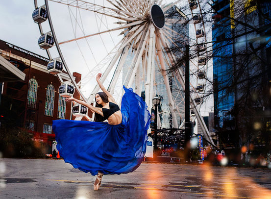 A dancer en pointe tilts sideways in a flowing blue skirt, with a Ferris wheel in the background, creating a striking balance of motion and urban vibrance.




A dancer en pointe tilts sideways in a flowing blue skirt, with a Ferris wheel in the background, creating a striking balance of motion and urban vibrance- captured by dance photographer in Atlanta