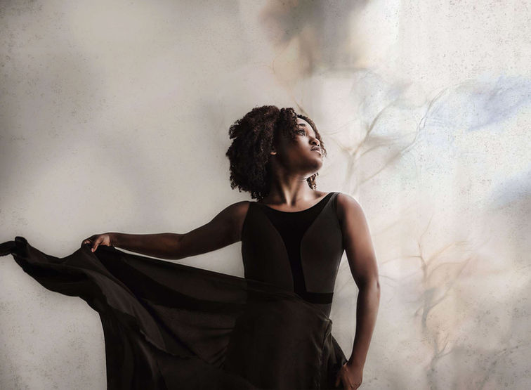 Dancer in studio in Roswell holding her skirt as she begins a movement