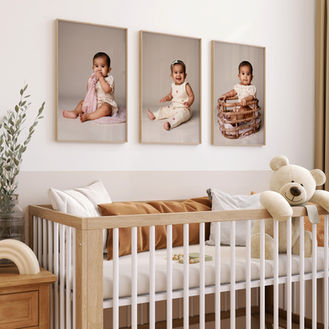 Three frames above the crib in a nursery, displaying baby photos that add warmth and tenderness to the space.