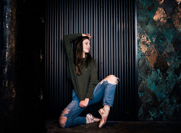 Ballerina posing against contemporary backround