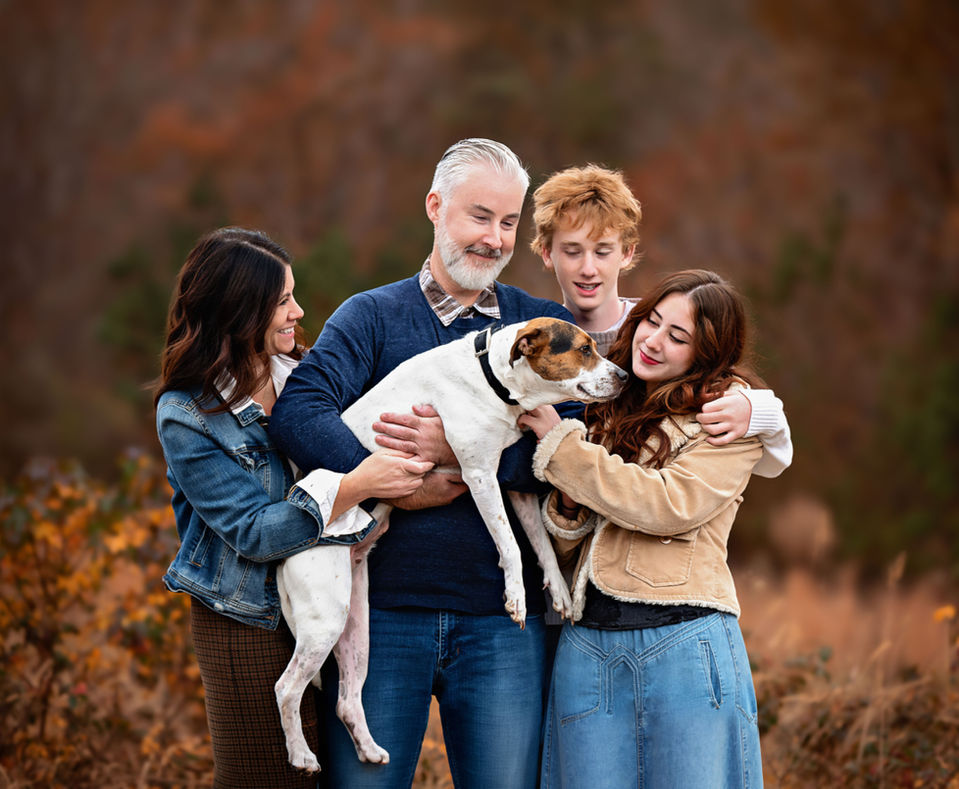 Outdoor family portrait with loyal dog