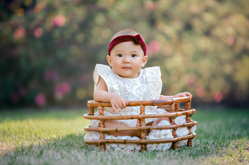Adorable baby girl in a basket