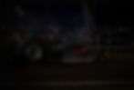 A yellow modified class tractor at a tractor pulling event